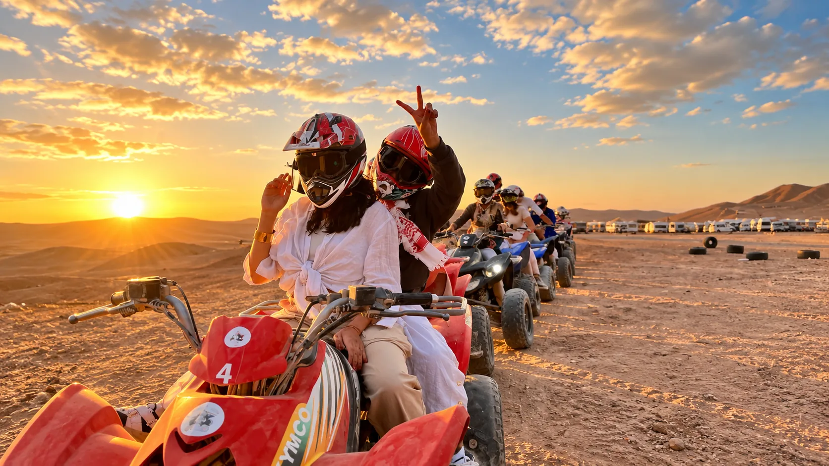 Quad biking group at sunset on the dunes